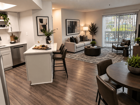 A modern kitchen with a dining table and chairs.
