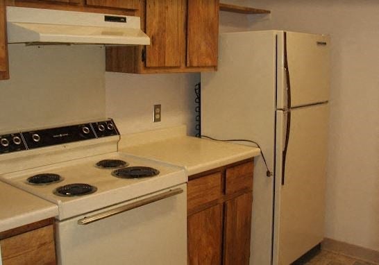 a kitchen with a stove and a refrigerator