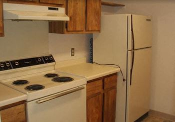 a kitchen with a stove and a refrigerator