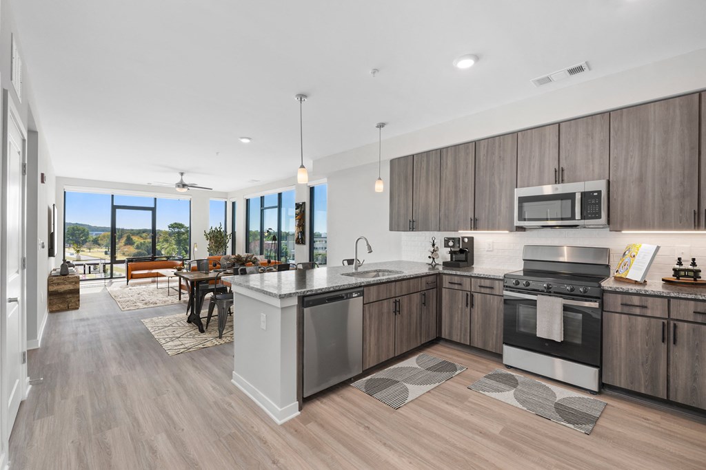 A modern kitchen with a large island and stainless steel appliances.