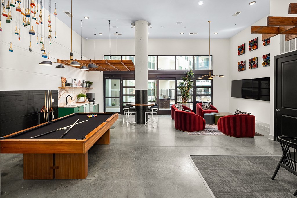 a large living room with a pool table and a television
