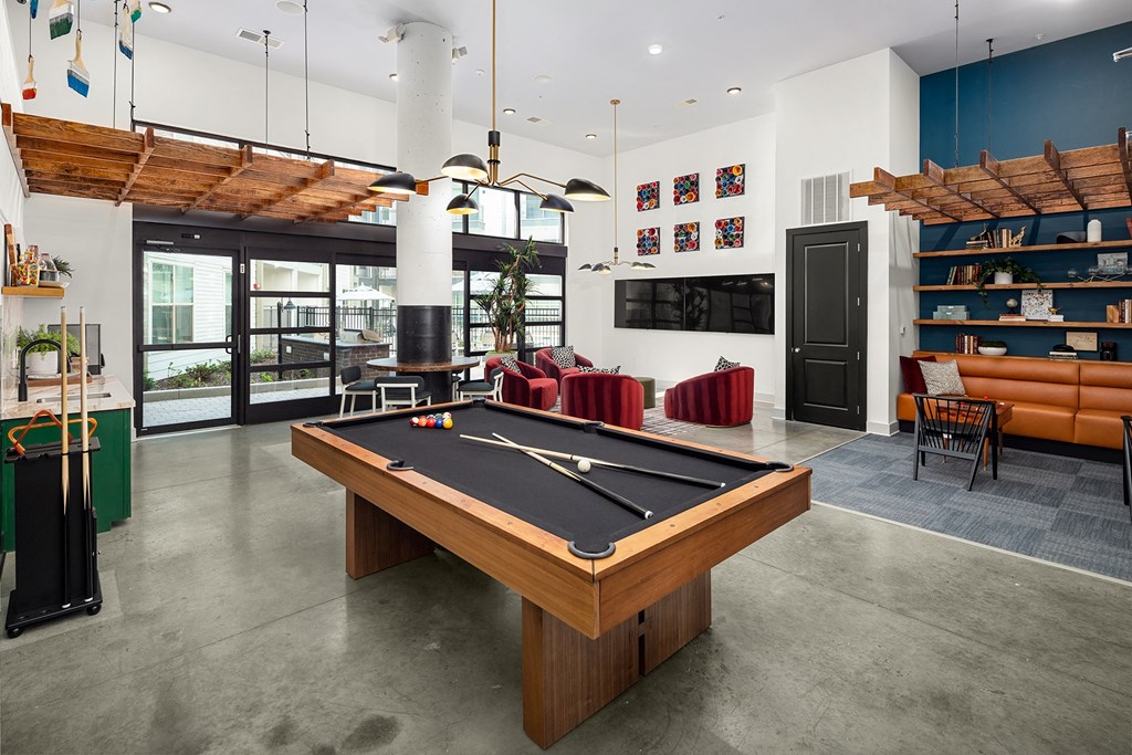 a games room with a pool table and a tv