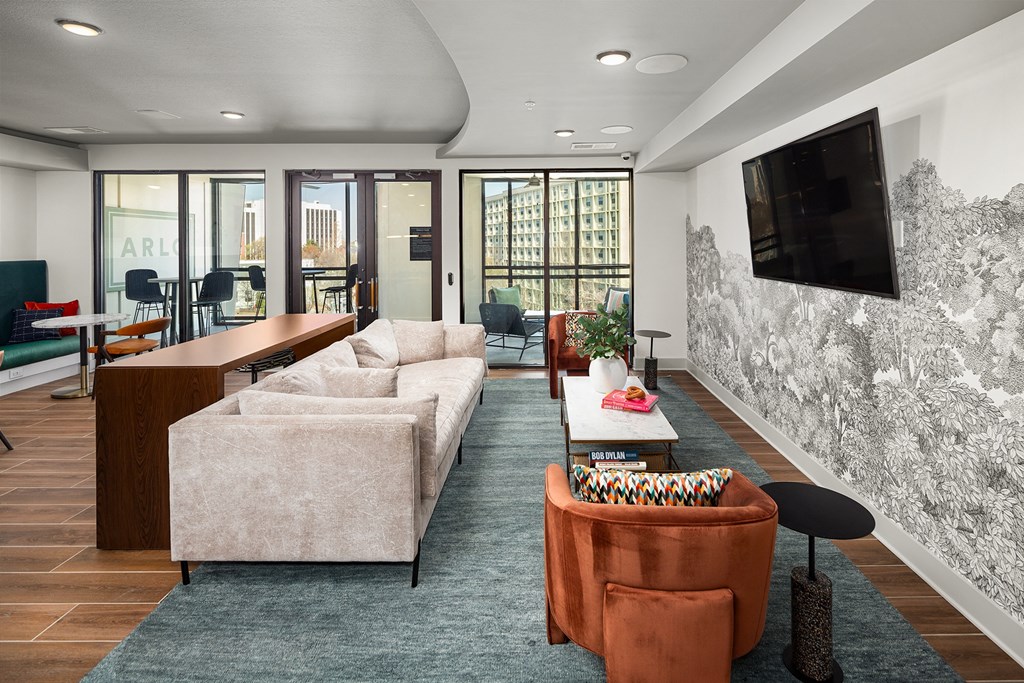 a living room with couches and a tv on the wall