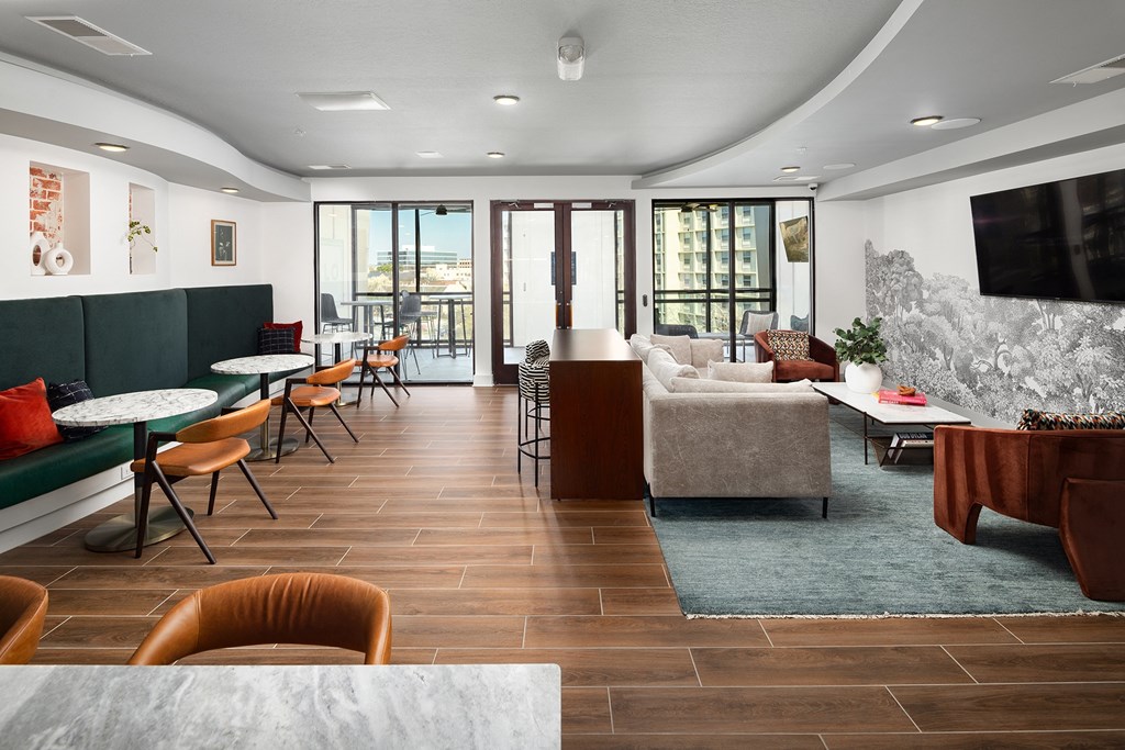 a living room with a couch and tables and a television