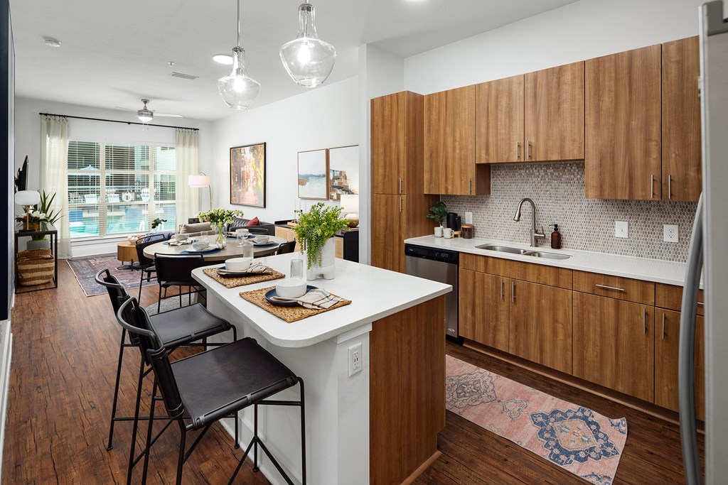 a kitchen and living room with a white counter top
