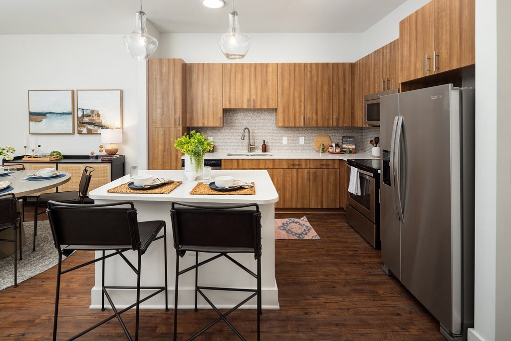 a kitchen with stainless steel appliances and a table with chairs