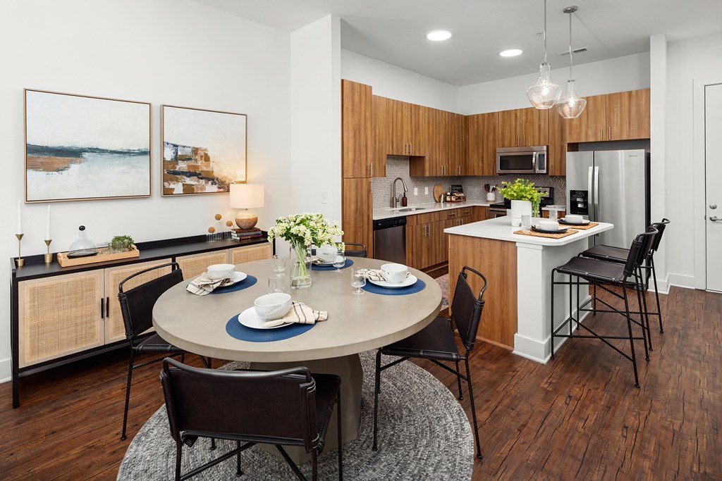 a dining room and kitchen with a table and chairs