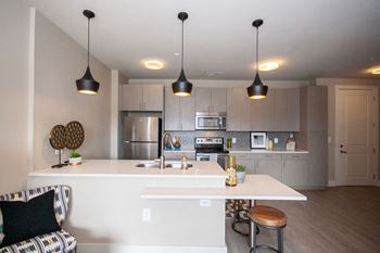 a view of the kitchen and living room in a bedroom plus den unit at the central apartments