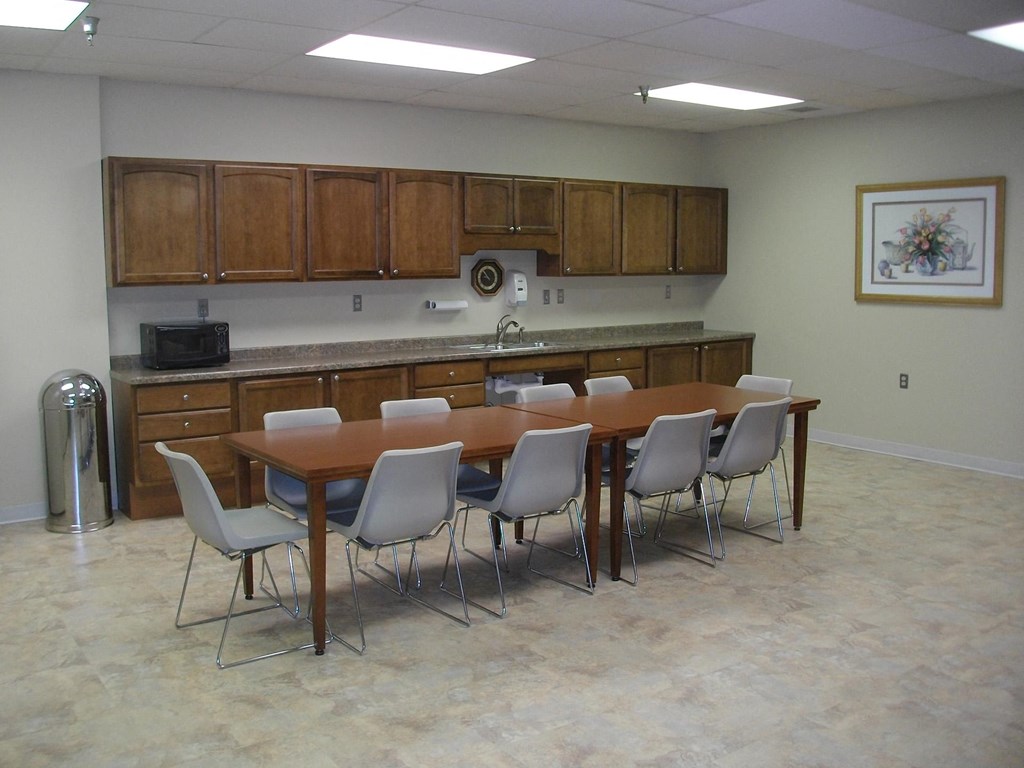 a dining room with a table and chairs