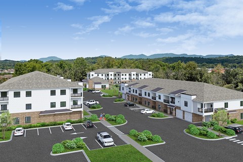 A large white building with a parking lot in front of it.