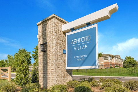 a sign villas with a building in the background