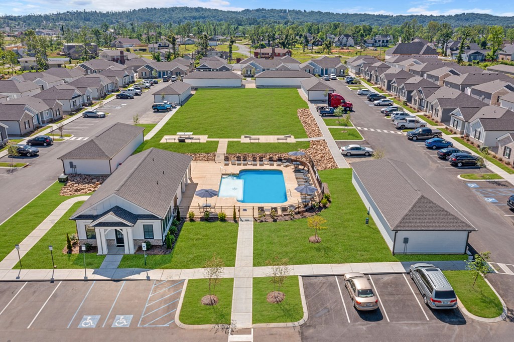an aerial view of a neighborhood of houses with a swimming pool