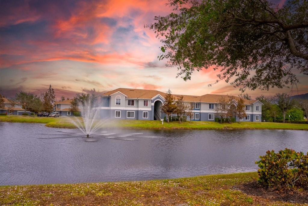A house with a fountain in front of it.
