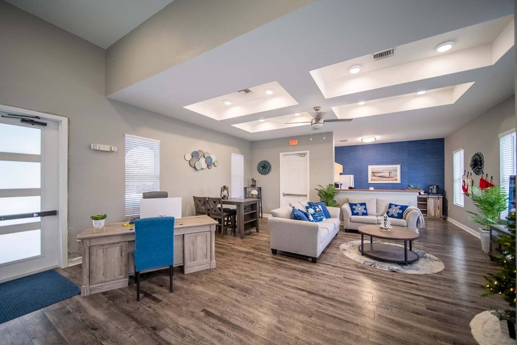 A living room with a blue accent wall and a white couch.