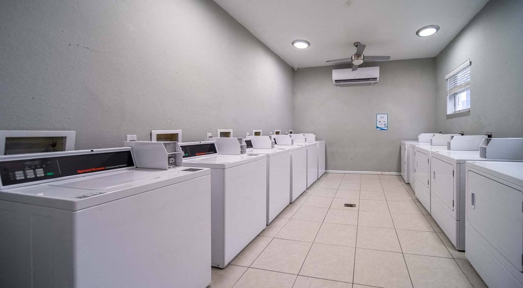 A row of washing machines in a laundromat.