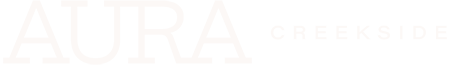 A green banner with the word AURA in white and CREEKSIDE underneath.