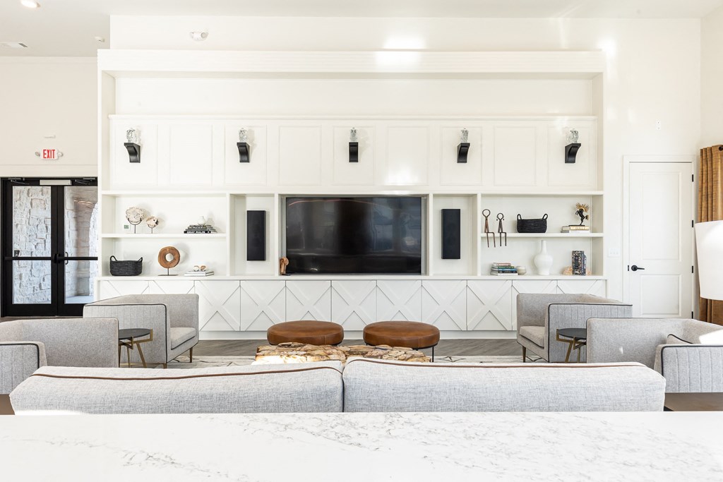 a living room with couches and chairs and a television