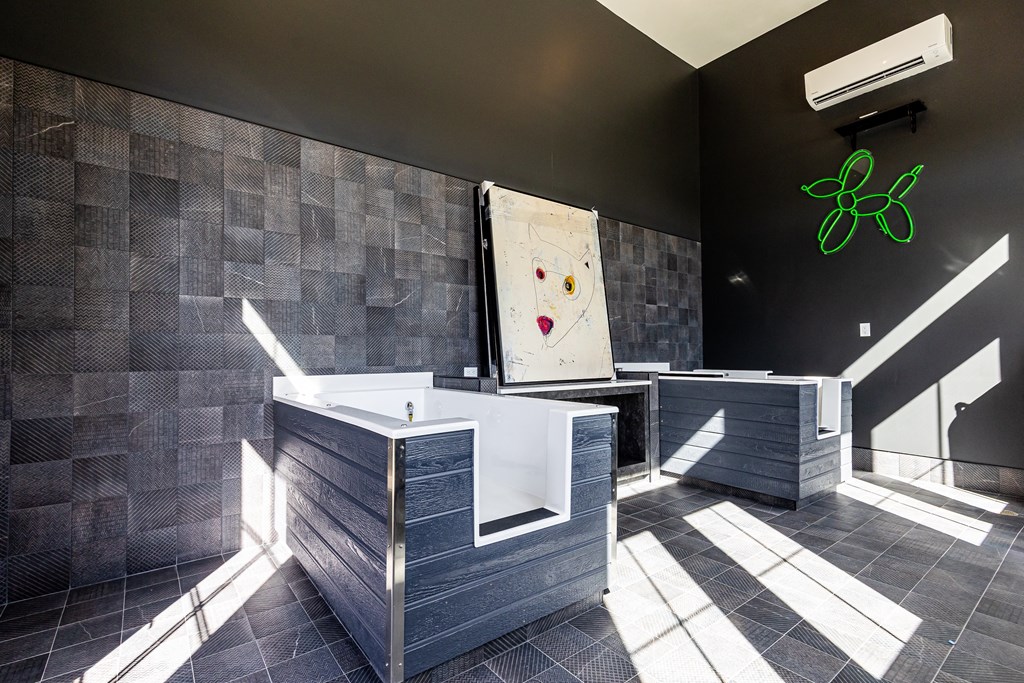 a bathroom with a large tub and a painting on the wall