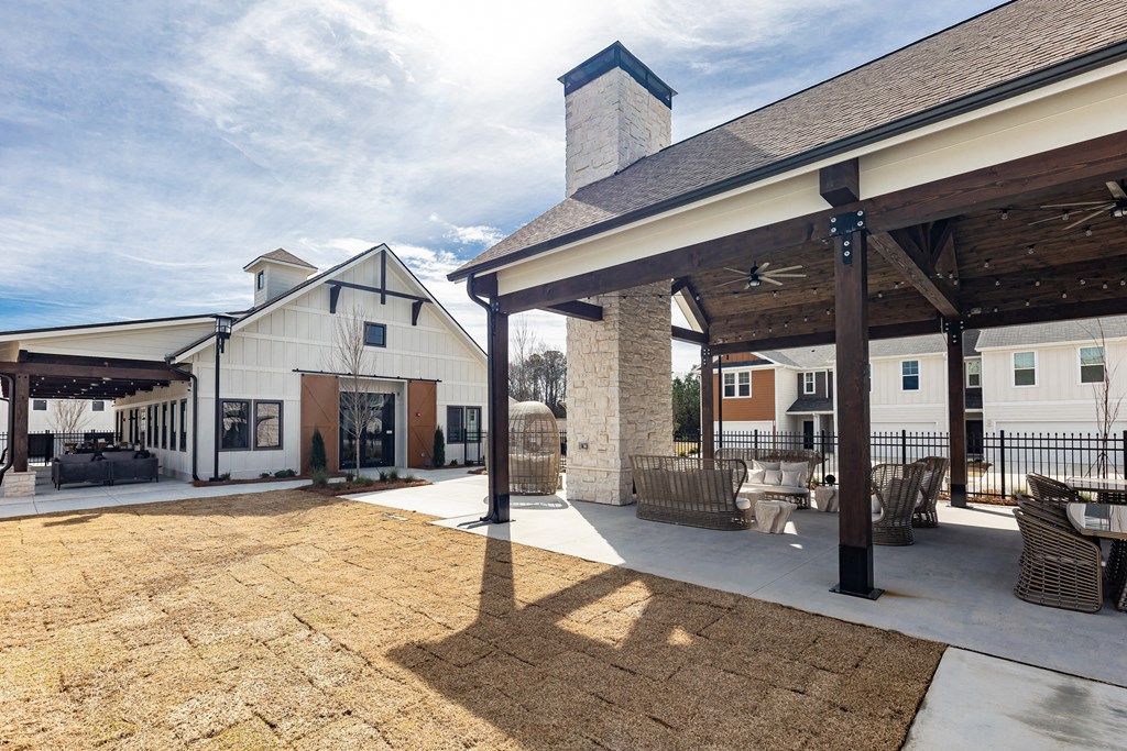 a patio with tables and chairs outside of a building