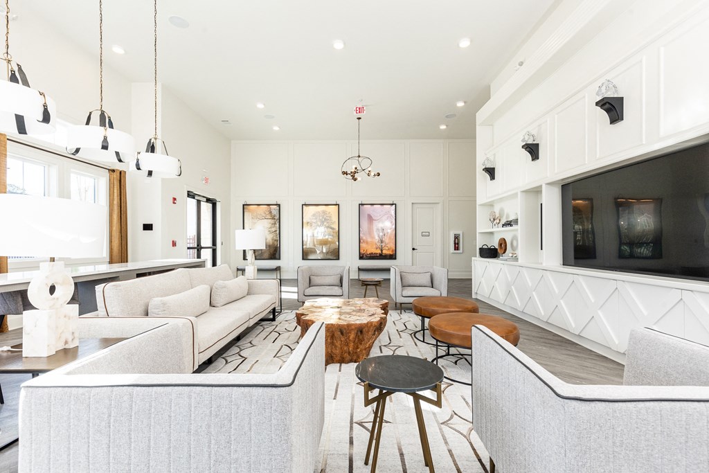 a living room with couches and chairs and a television