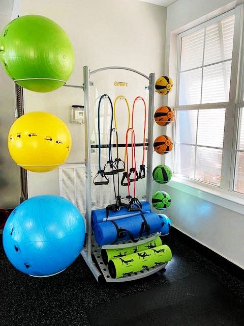 a room with a bunch of exercise equipment in it
