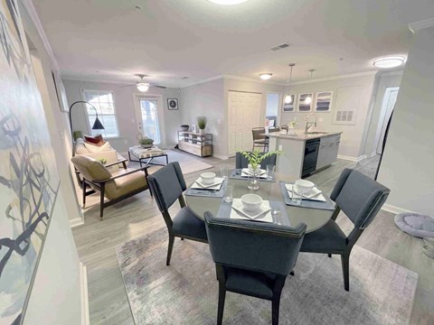 A dining room with a table set for six.