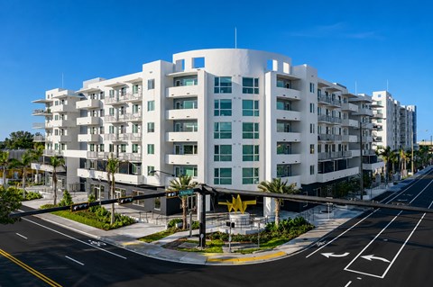 A modern white building with a blue sky in the background.