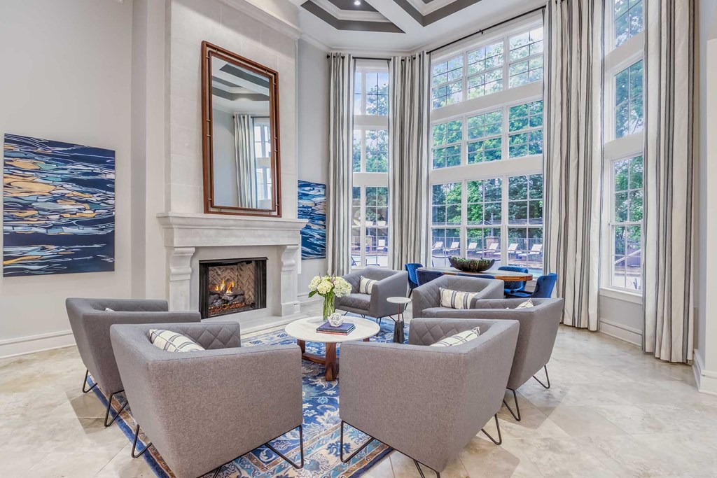 A living room with a fireplace and a painting on the wall.