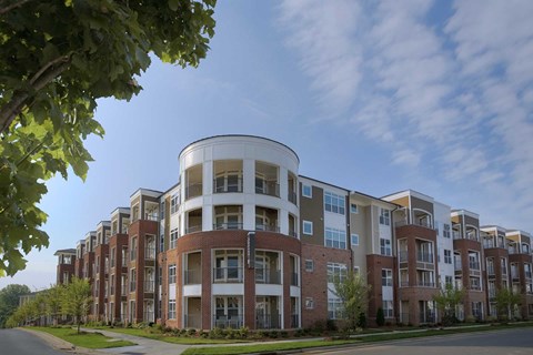 A large apartment complex with a curved building design.