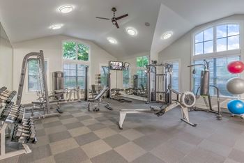 A spacious home gym with a variety of exercise equipment.