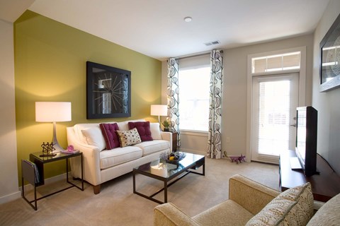 A living room with a white couch and a coffee table.
