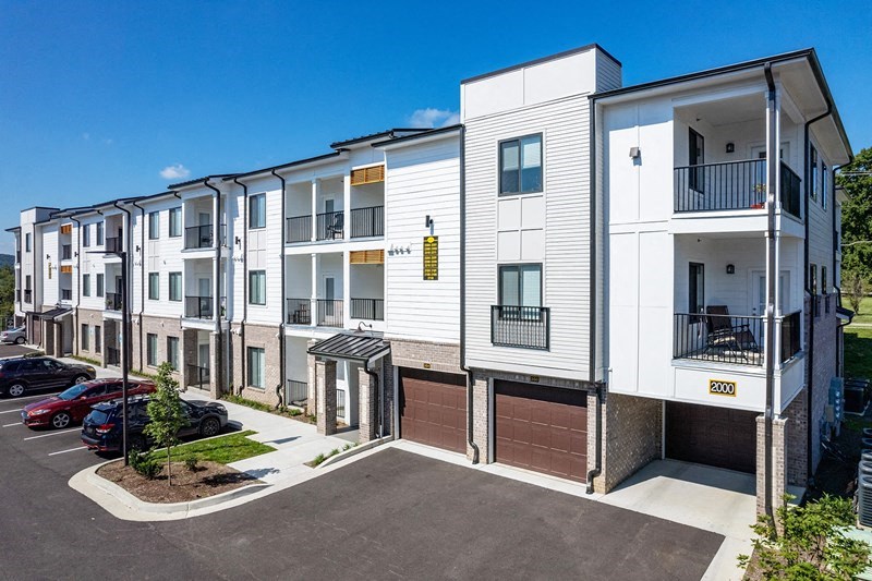modern apartment buildings with balconies and a parking lot