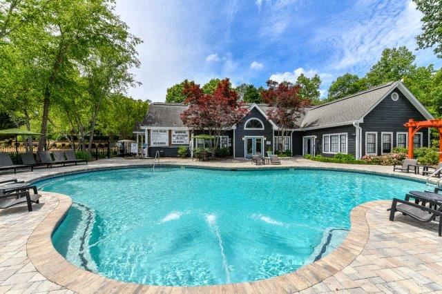 a large pool with a house in the background - Photo Gallery 1