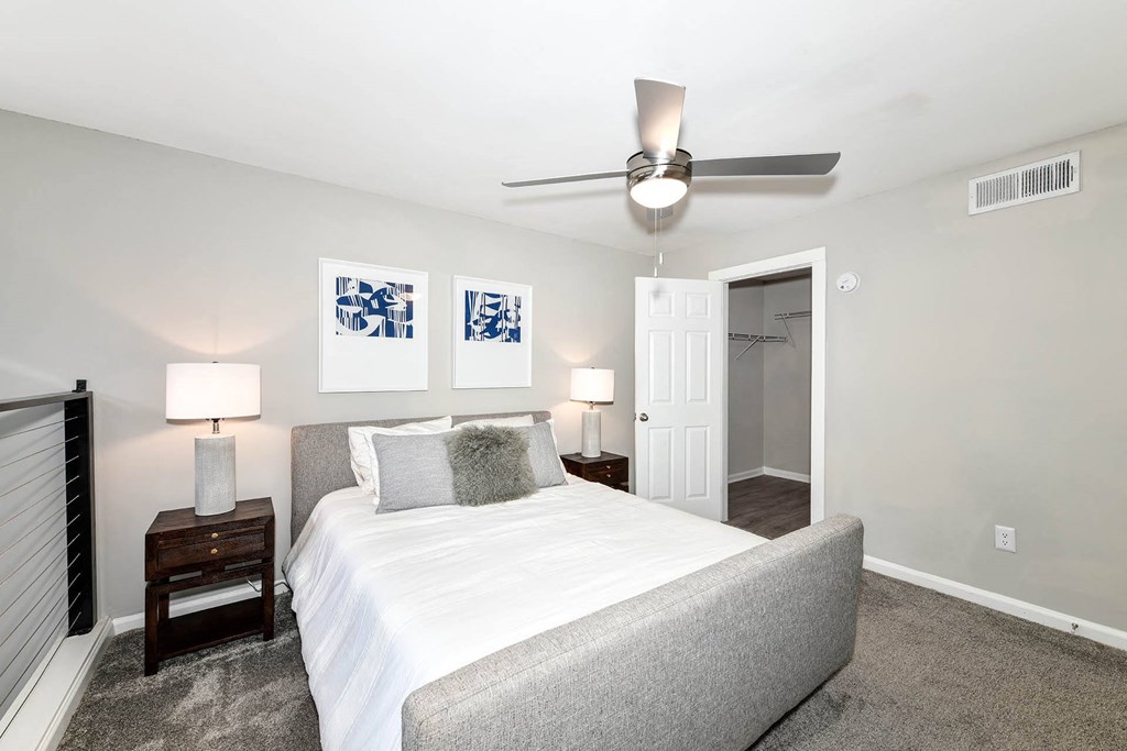 a bedroom with a bed and a ceiling fan  at District at Vinings, Georgia, 30339