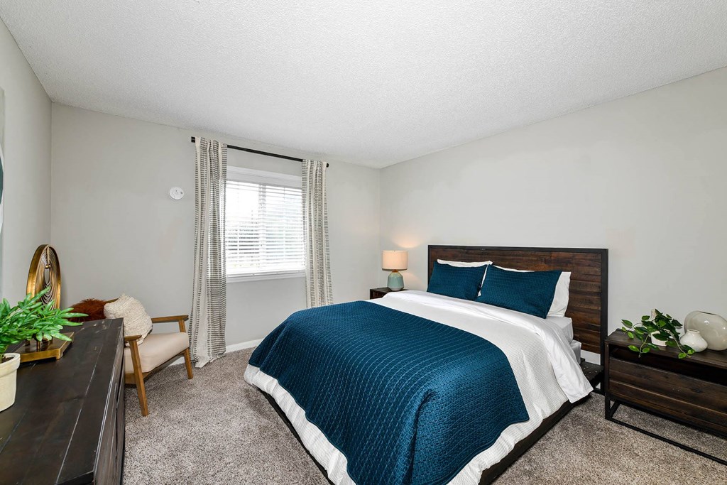 our apartments offer a bedroom with a king sized bed  at District at Vinings, Atlanta, 30339