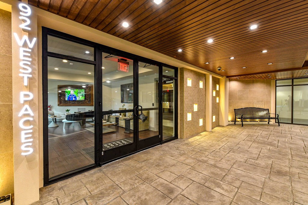 a building with a large glass door and a bench in front of it