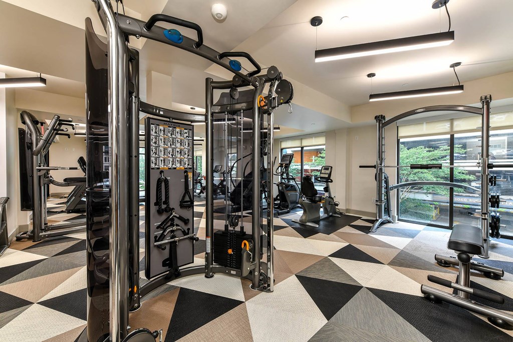 a spacious fitness center with cardio machines and weights