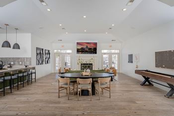 A dining room with a table set for six.