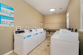 A laundromat with rows of washers and dryers.