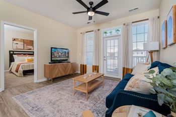 A living room with a ceiling fan and a television.