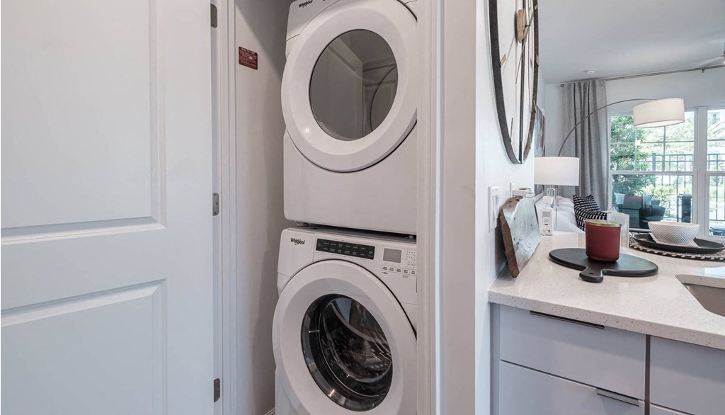 a white washer and dryer in a white laundry room