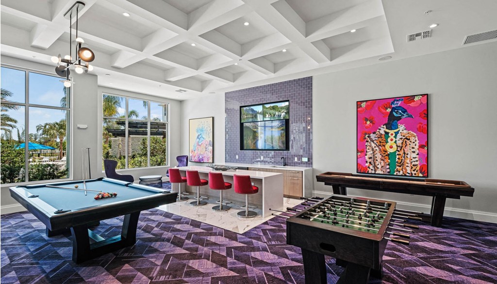 a game room with a pool table and a bar