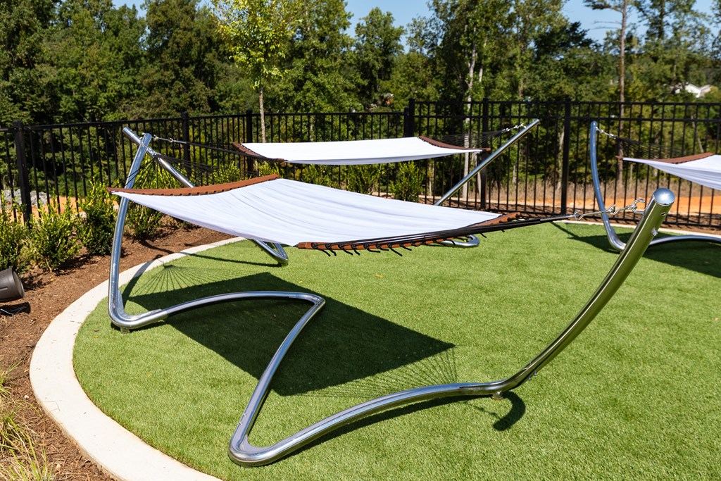 a hammock area in a park with trees in the background