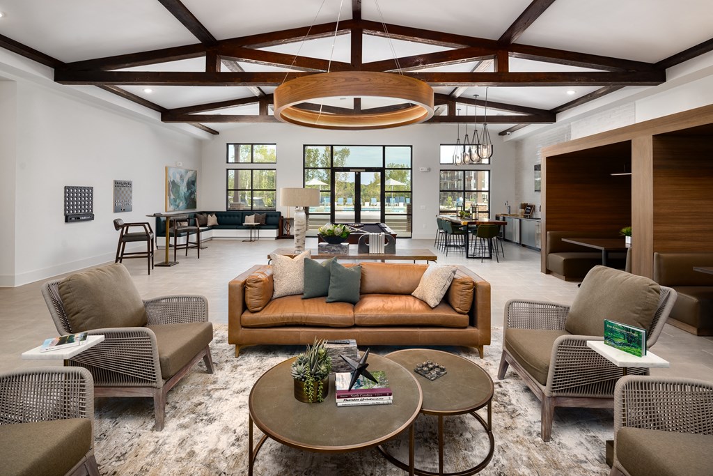 Belmont, NC Apartments - Banks at Mt. Holly - Clubhouse with High Ceilings, Seating Area, and Kitchen