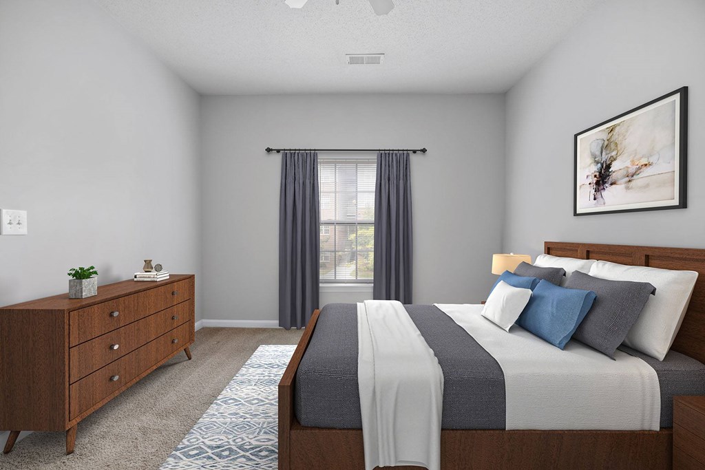 A bedroom with a large bed and a dresser.