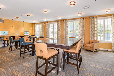 A conference room with a long table and chairs.