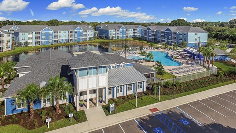 A large building with a pool in front of it.
