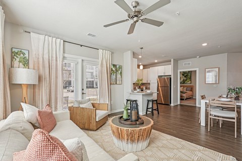 A living room with a white couch and a wooden coffee table.