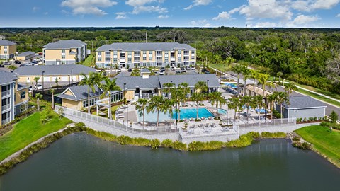 A resort with a pool and a lake.