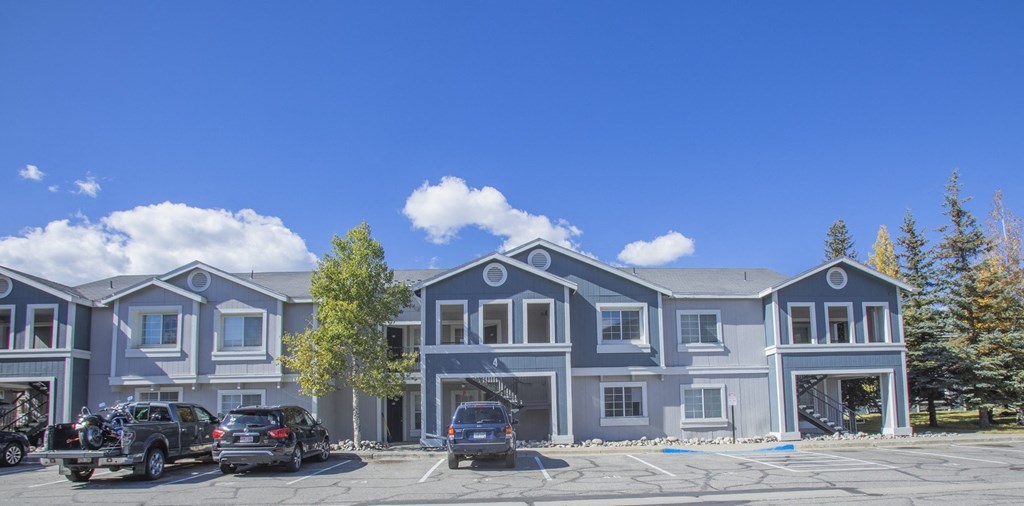 a large blue building with cars parked in front of it